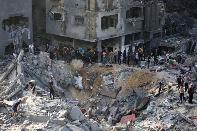 Palestinians examine the aftermath of an Israeli strike the previous night in the Jabalia refugee camp in the Gaza Strip. (AFP)