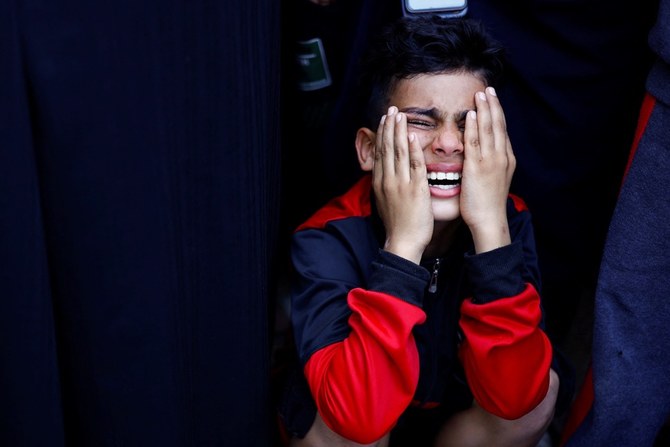 A Palestinian boy mourns his father who was killed by an Israeli strike. (Reuters)