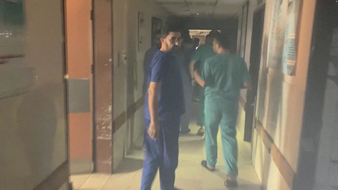 Medical staff look at the damage in the smoke-filled wards inside Al-Shifa hospital following an Israeli raid on Nov. 15, 2023. (Gaza Ministry of Health via Reuters)