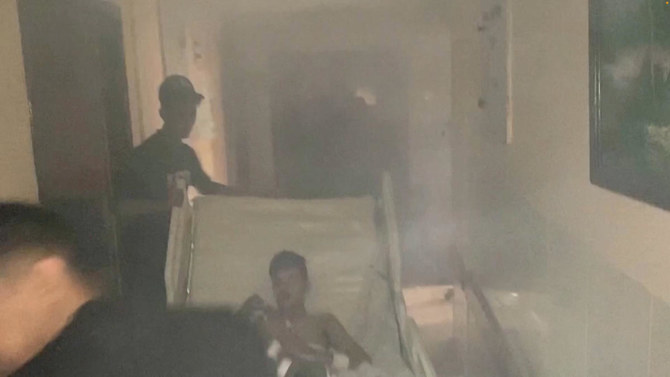 Medics move a patient through the smoke-filled corridors inside Al-Shifa hospital following an Israeli raid on Nov. 15, 2023. (Gaza Ministry of Health via Reuters)