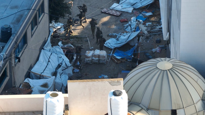 Israeli soldiers walk at the Al-Shifa hospital complex in this still image from handout video obtained Nov. 15, 2023. (Israeli Defense Forces via Reuters)