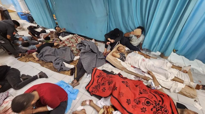 Palestinians wounded in Israeli strikes lie on the floor as they are assisted at the Indonesian hospital after Al-Shifa Hospital has gone out of service amid Israeli ground offensive, in the northern Gaza Strip on November 16, 2023. (Reuters)