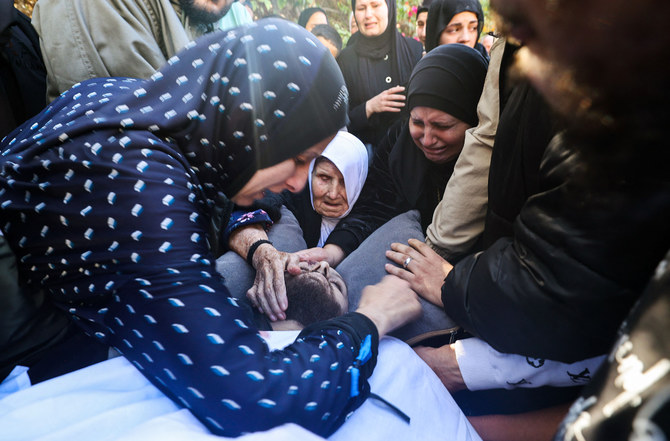 Palestinians mourn over a body following an Israeli military raid in the occupied West Bank Jenin refugee camp on November 17, 2023. (AFP)