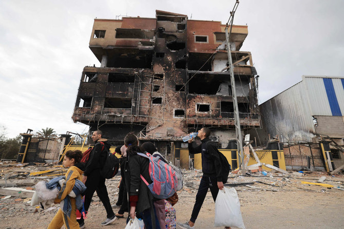 Palestinians fleeing the fighting in war-torn Gaza walk on Salaheddine road in the Zeitoun district of the southern part of the Gaza Strip on November 19, 2023, as battles between Israel and the Hamas movement continue. (AFP)