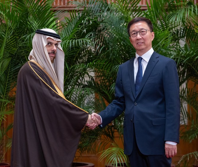 Saudi Arabia’s Foreign Minister Prince Faisal bin Farhan shakes hands with China’s Vice President Han Zheng in Beijing. (SPA)