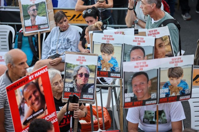 Family members, friends and supporters of hostages held in the Gaza Strip since the October 7 attack by Hamas militants in southern Israel, hold images of those taken during a protest calling for their release outside the Prime Minister's office in Jerusalem (AFP)