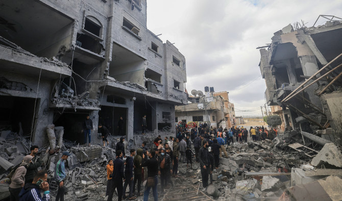 Palestinians walk amid the rubble of buildings damaged during an Israeli strike on Rafah in the southern Gaza Strip on November 20, 2023. (AFP)