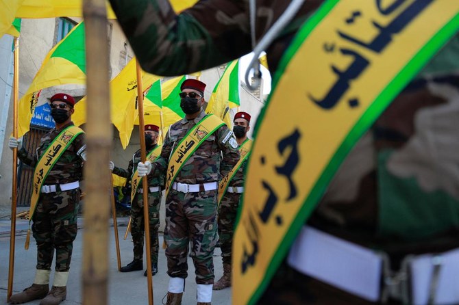 Members of the Hezbollah brigades, Kataeb Hezbollah, attend the funeral of Fadel al-Maksusi, a fighter who was also part of the “Islamic resistance in Iraq”, the group that has claimed all recent attacks against US troops in Iraq and Syria (AFP)