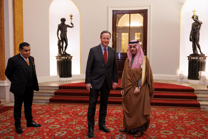 British Foreign Secretary David Cameron greets the Minister of Foreign Affairs of Saudi Arabia, Faisal bin Farhan Al-Saud, as he welcomes Arab and Islamic counterparts to Lancaster House in London on Nov. 22, 2023. (Reuters)