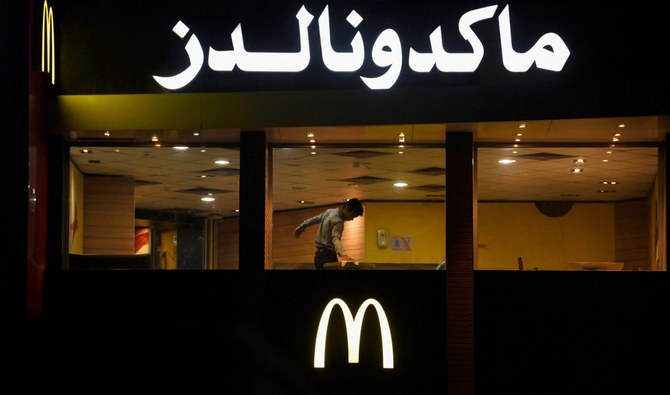 A worker cleans a table in an empty McDonald’s restaurant as a result of the boycott of Western brands in Egypt due to the Israeli bombardment in Gaza, in Cairo, Egypt, November 20, 2023. (Reuters)
