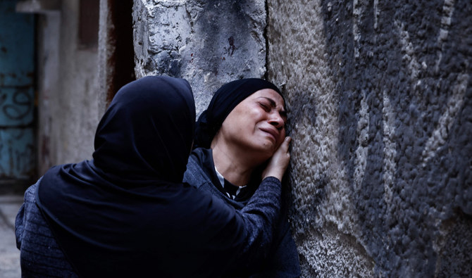 Relatives cry during the funeral of Palestinian Hussein Abu Jaasa, 52, who was killed during an Israeli raid in the Balata refugee camp, in Nablus, occupied West Bank, on Wednesday. (AFP)