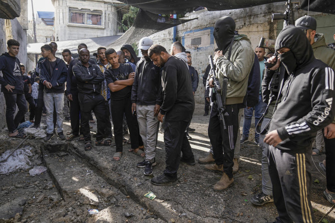 Palestinians inspect the site of an Israeli strike after a military raid in the town of Tulkarem, West Bank, on Nov. 22, 2023. (AP)
