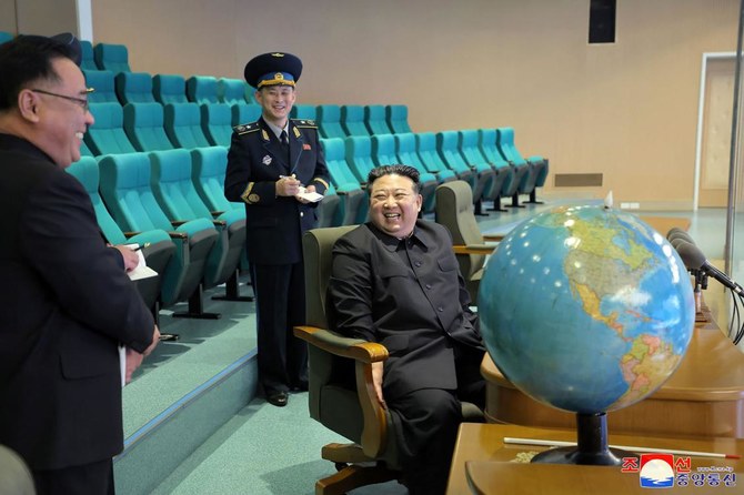 North Korea’s leader Kim Jong Un, right, prepares for the operation of the reconnaissance satellite Malligyong-1 during a visit at the State Directorate of Aerospace Technology in Pyongyang last week. (KCNA via KNS/AFP)