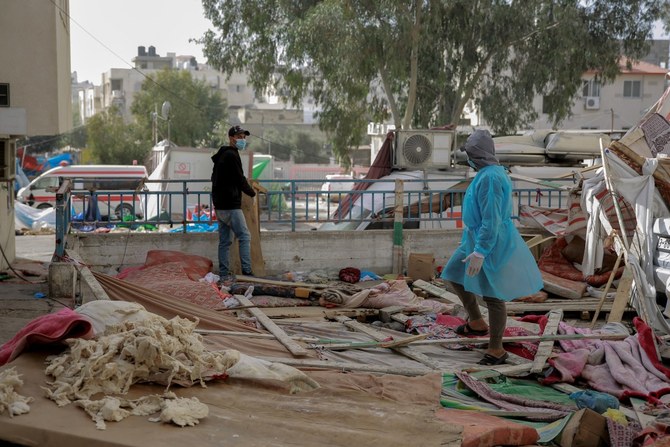 Palestinians check the damage outside the Al-Shifa hospital in Gaza City on November 26, 2023. (File/AFP)
