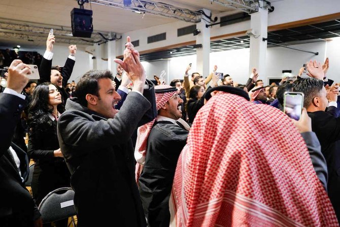 Members of Saudi Arabia’s Royal Commission for Riyadh City celebrate on Nov. 28, 2023 in Paris after winning the bid to host the 2030 World Expo. (AFP)