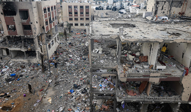 Palestinians inspect the destruction caused by Israeli strikes in Wadi Gaza, central Gaza strip. some buildings in the besieged enclave have been reduced to piles of broken concrete and metal rods. (AFP)