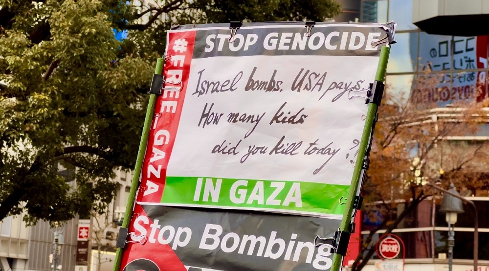 Participants painted red tear drops on a carton carpet on the ground, others cried out against the “Israeli apartheid regime and genocide war to exterminate the Palestinians.” (ANJ)