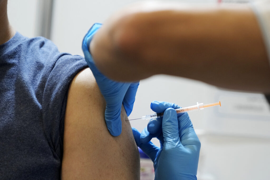 From the year starting next April, people aged 65 or older and those aged 60 to 64 with severe underlying diseases will be eligible for routine COVID-19 vaccinations. (AFP)