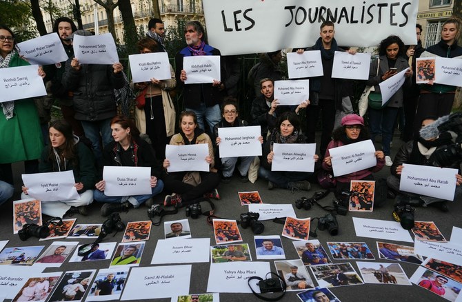 Protesters display the names and photographs of journalists who have been killed in Gaza since October 7. Nov. 11, 2023 (AFP)