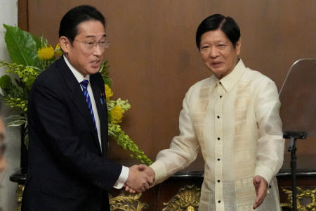 Japanese Prime Minister Fumio Kishida shakes hands with Philippine President Ferdinand 