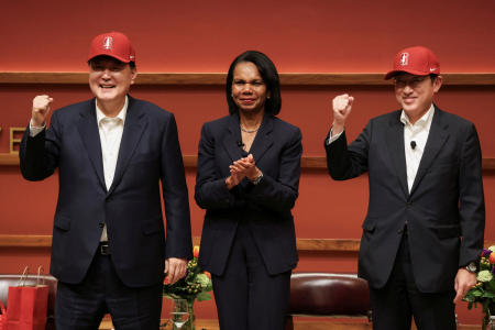 Japan's Prime Minister Fumio Kishida and South Korea's President Yoon Suk-yeol pose for a photo while wearing Stanford baseball caps with former US Secretary of State Condoleezza Rice during a summit discussion on the sidelines of the Asia-Pacific Economic Cooperation (APEC) summit, at the Stanford, California, US, November 17, 2023. (Reuters)