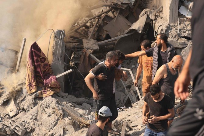 People search for victims and survivors through the rubble of a building destroyed in an Israeli strike on the Bureij refugee camp in the central Gaza Strip on Nov. 2, 2023. (AFP)