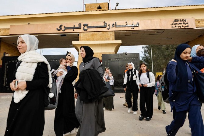 Passengers fleeing from the Gaza Strip arrive at the Egyptian side of the Rafah border on Nov. 22, 2023. (AFP)