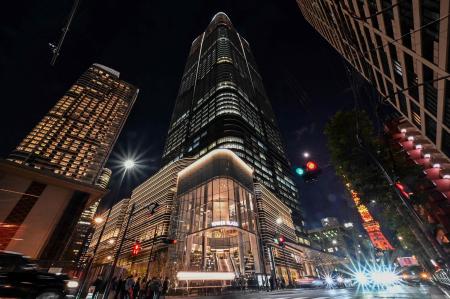 This general view shows a night view of Tokyo's newest skyscraper, the Azabudai Hills Mori JP Tower complex, after its official opening earlier in the day as Tokyo Tower (back R) looms nearby in central Tokyo on November 24, 2023. (AFP)
