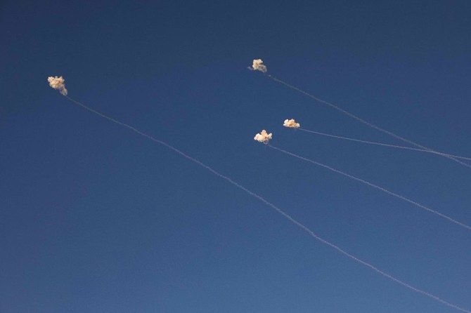 Rockets fired from southern Lebanon are intercepted above a position across the border near Kibbutz Dan in northern Israel on Nov. 7, 2023. (AFP)