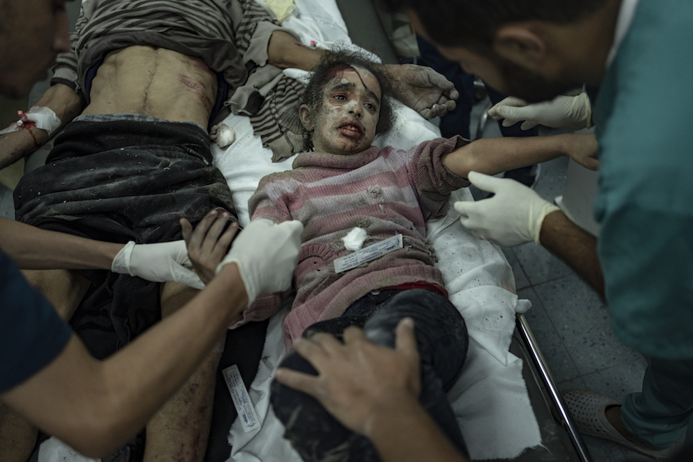 Palestinians wounded in the Israeli bombardment of the Gaza Strip arrive at a hospital in Rafah. (AP)
