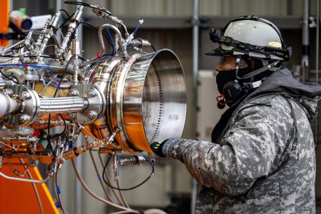 A staff member checks up a rockect engine before a test, which uses biomethane as fuel, at the test site of satellite-launch startup Interstellar Technologies, in Taiki of Hokkaido Prefecture on December 7, 2023. (AFP)