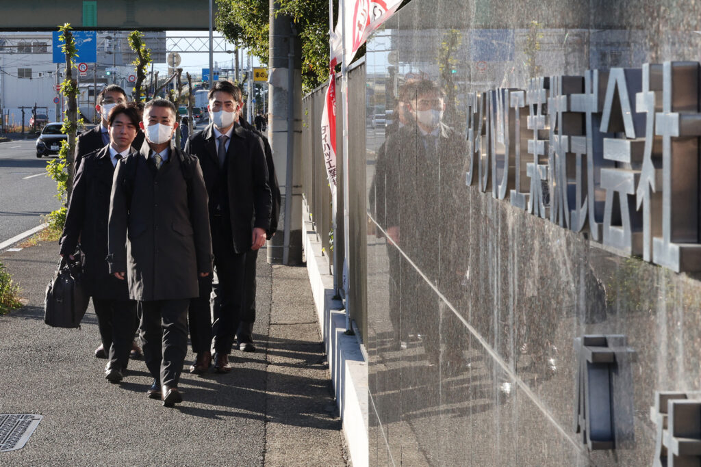 Officials from Japan's Ministry of Land, Infrastructure, Transport and Tourism arrive at the Daihatsu Motor headquarters for inspection work in Ikeda, Osaka prefecture on December 21, 2023. (AFP)