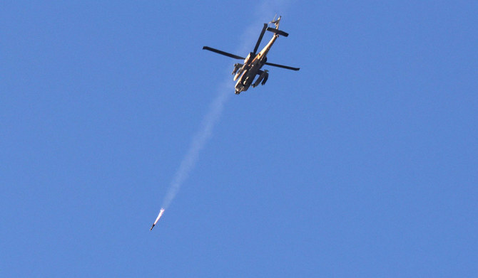 An Israeli air force attack helicopter fires a missile while flying over the border with the Gaza Strip near southern Israel on December 2, 2023, after battles resumed between Israel and Hamas militants. (AFP)