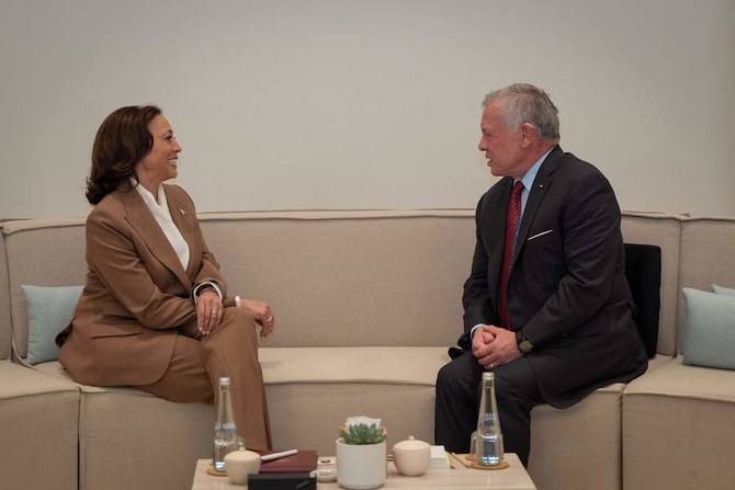 A handout picture released by the Jordanian Royal Palace shows King Abdullah II meeting US Vice President Kamala Harris on the sidelines of the COP28 climate summit in Dubai, on Dec. 2, 2023. (AFP/Jordanian Royal Hashemite Court)