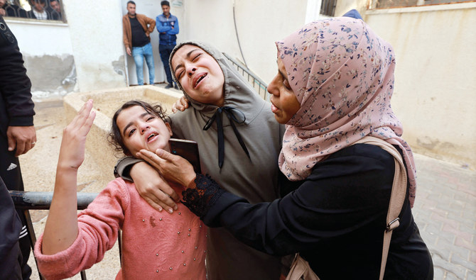 Family members mourn a baby girl in the courtyard of the Al-Najjar hospital on Sunday. She was killed in an Israeli strike in Rafah in the southern Gaza Strip. (AFP)