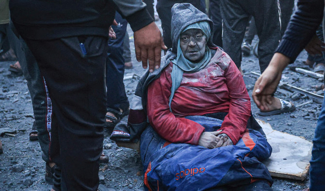 A woman injured in an Israeli strike sits amid the rubble in Rafah in the southern Gaza Strip. (AFP)