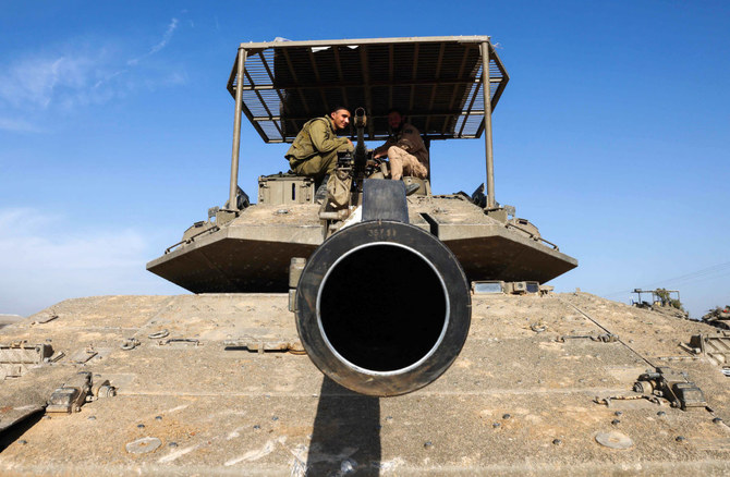Israeli troops and military vehicles are positioned near the border with the Gaza Strip on December 3, 2023, amid continuing battles between Israel and the militant group Hamas. (AFP)