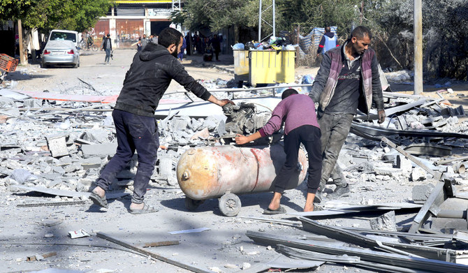 Palestinians salvage their belongings from the destruction by the Israeli bombardment of the Gaza Strip in Deir Al-Balah. (AP)