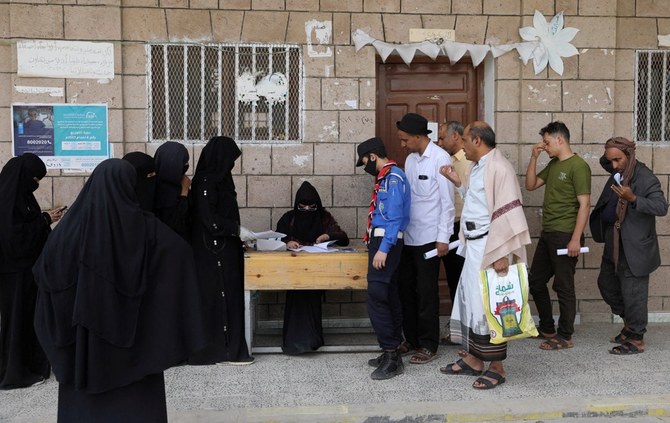 Beneficiaries of World Food Program assistance queue at a food distribution center amid exacerbating food shortages, in Sanaa. (Reuters)