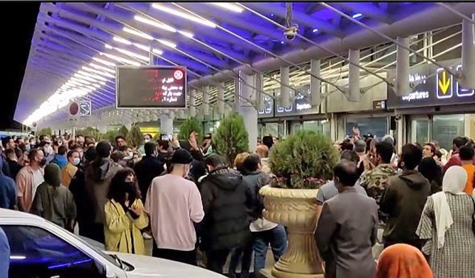 This grab taken from a UGC video made available on the ESN platform on October 19, 2022 shows people reacting as they gather at Imam Khomeini International Airport in Tehran to welcome Elnaz Rekabi, an Iranian climber who caused a sensation by competing at an event abroad without a hijab. (AFP/File)