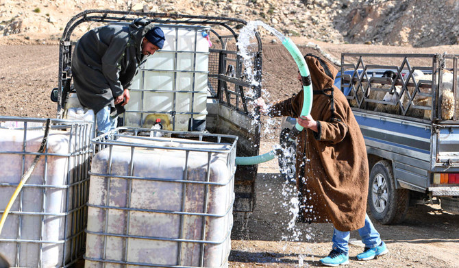 Farmers bring water by tanks for their livestock in the remote village of Ouled Omar, 180 kilometres southwest of the Tunisian capital, on November 28, 2023, with the north African country grappling with its worst water scarcity in years as it enters its fourth year of drought. (AFP)