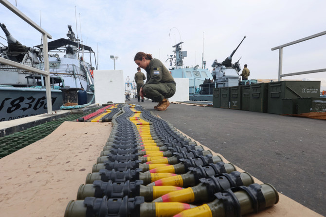 Israeli navy soldiers prepare ammunition and ships before setting out to the Mediterranean sea waters around the Gaza Strip, at the Israeli naval base in Ashdod, on December 7, 2023, amid continuing battles between Israel and the militant group Hamas. (AFP)
