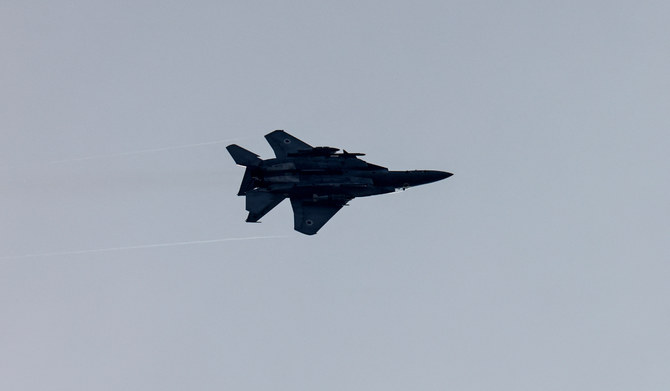 An Israeli military fighter aircraft flies near the Israel-Gaza border, amid the ongoing conflict between Israel and the Palestinian Islamist group Hamas, as seen from southern Israel, December 7, 2023. (REUTERS)