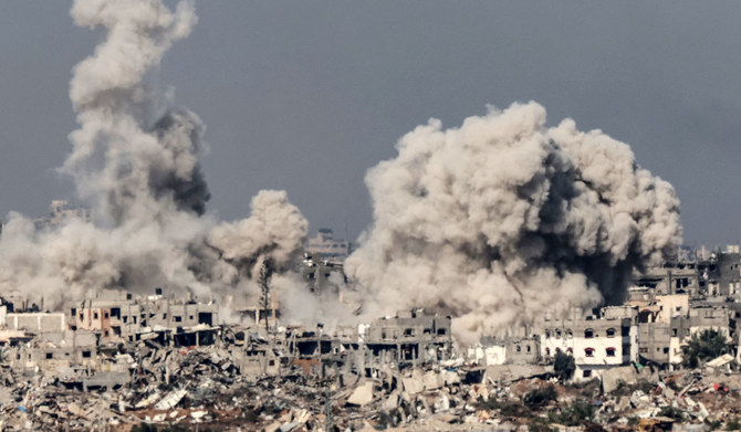 A picture taken from southern Israel near the border with the Gaza Strip on December 8, 2023, shows smoke rising above buildings during an Israeli strike in northern Gaza, amid continuing battles between Israel and the militant group Hamas. (AFP)