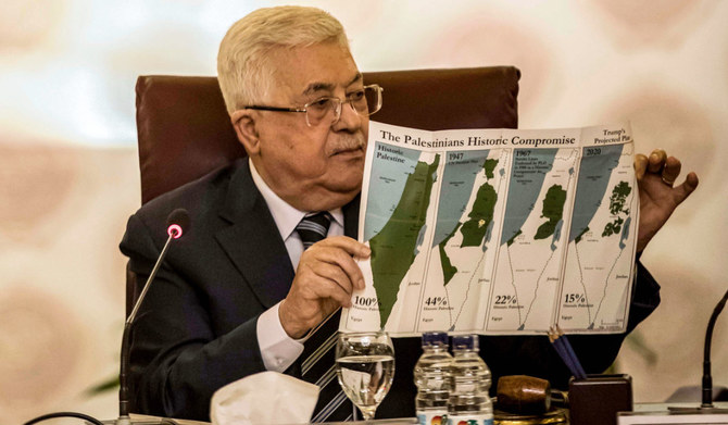 Palestinian president Mahmud Abbas holds a placard showing maps of (L to R) historical Palestine, the 1947 United Nations partition plan on Palestine, the 1948-1967 borders between the Palestinian territories and Israel, and a current map of the Palestinian territories without Israeli-annexed areas and settlements, as he attends an Arab League emergency meeting discussing the US-brokered proposal for a settlement of the Middle East conflict at the league headquarters in the Egyptian capital Cairo on February 1, 2020. (AFP)