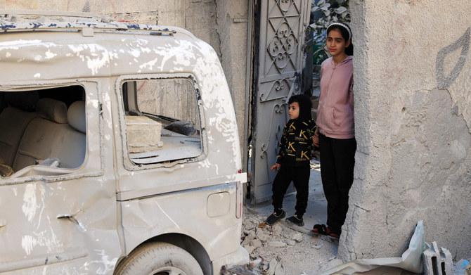 Palestinian children stare at the destruction following an early morning Israeli strike in Rafah in the southern Gaza Strip on December 9, 2023, amid continuing battles between Israel and the militant group Hamas. (AFP)