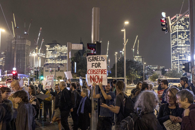 Israeli left-wing activists hold a demonstration near the Ministry of Defence in Tel Aviv on December 5, 2023, calling for a ceasefire and exchange of hostages amid continuing battles between Israel and the Palestinian militant group Hamas. (AFP)