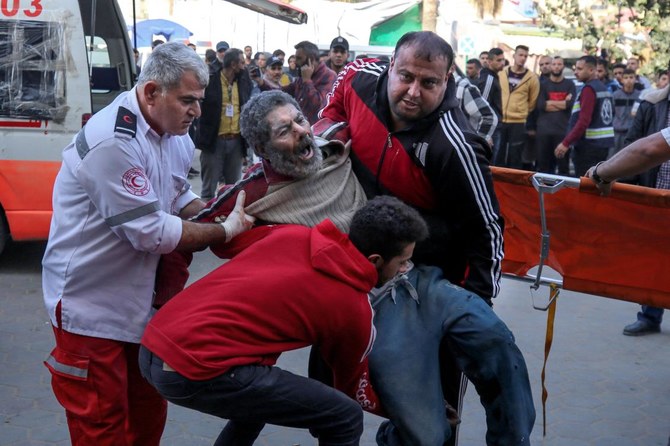 Palestinians injured following Israeli strikes on Al-Maghazi refugee camp are transferred to Al-Aqsa hospital in Deir Balah in the central Gaza Strip on December 11, 2023, amid ongoing battles between Israel and the Palestinian Hamas movement. (AFP)