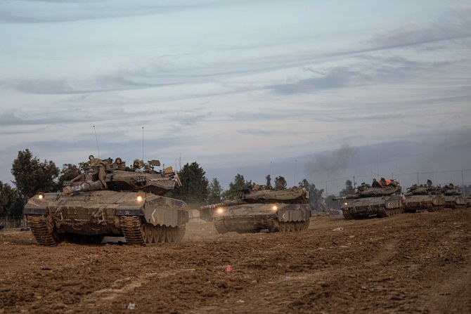 Israeli soldiers move tanks at a staging area near the border with the Gaza Strip. (AP)