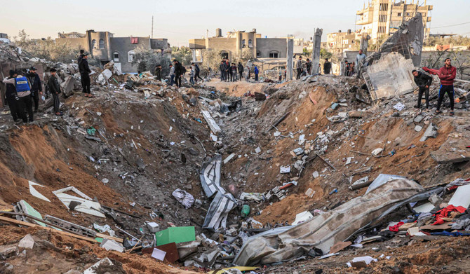 People search building rubble for items to salvage following an early morning Israeli strike in Rafah in the southern Gaza Strip on December 12, 2023, amid ongoing battles between Israel and the Palestinian militant group Hamas. (AFP)
